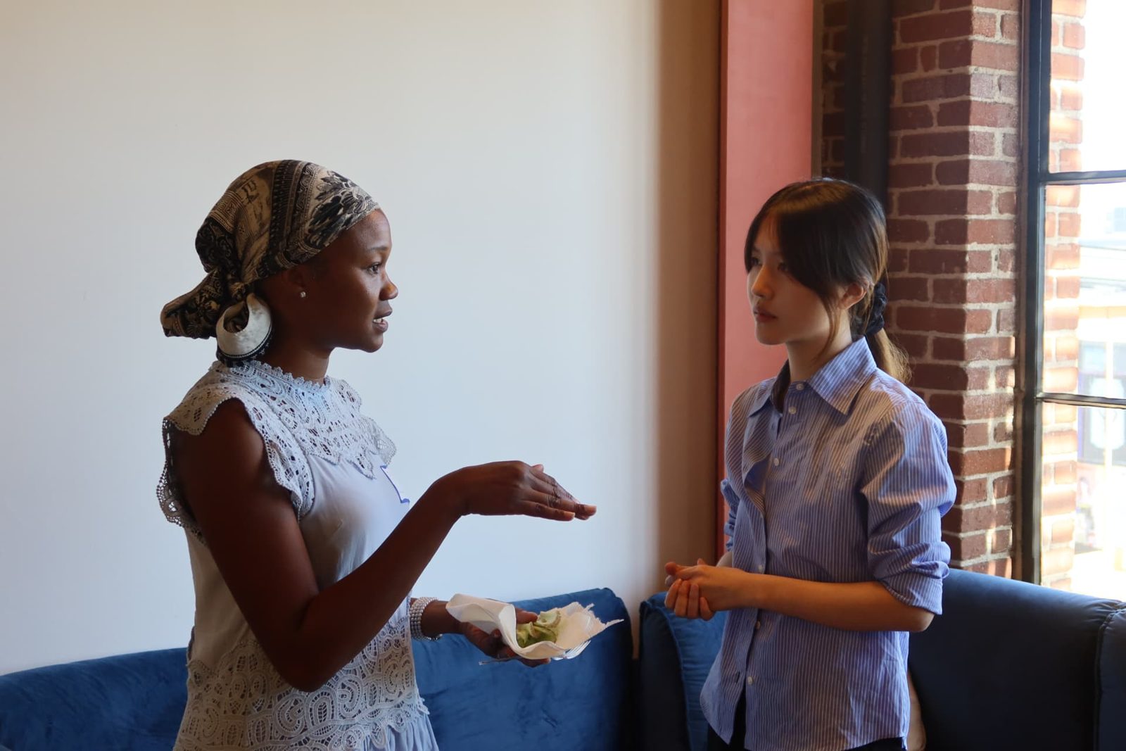 Two participants talking by the window